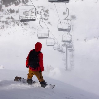 Jones rider Marcus Cassidy wears the Men's Shralpinist Stretch Recycled Bibs in Sierra Brown