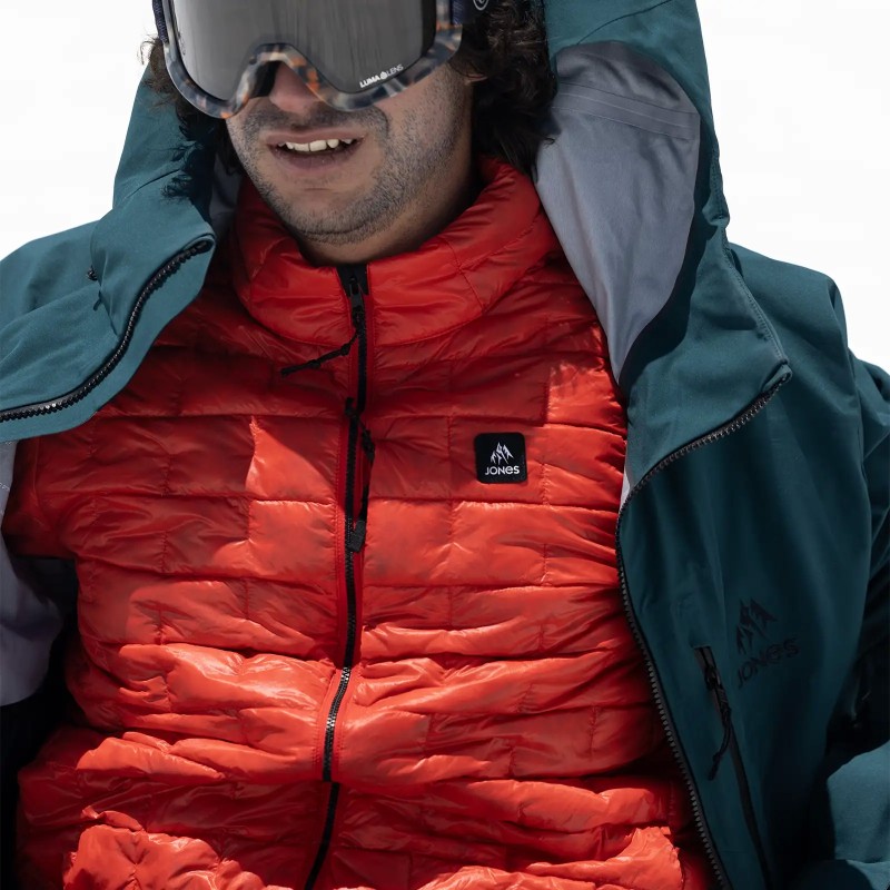 Jones rider Inaki Odriozola wears the Men's Ultra Re-Up Down Recycled Jacket in Lava Red